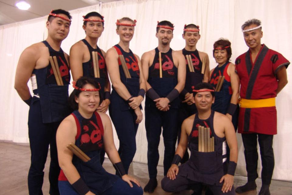 Members of the Kenny Endo Taiko Ensemble gather for a photo dressed in performance attire